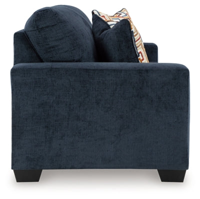 Ashley Furniture Aviemore sofa shown from the side, featuring plush cushions and a modern design in a neutral fabric.