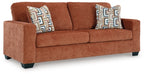 Ashley Furniture Aviemore sofa with plush cushions and wooden legs, shown from an angled view.