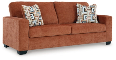 Ashley Furniture Aviemore sofa with plush cushions and wooden legs, shown from an angled view.