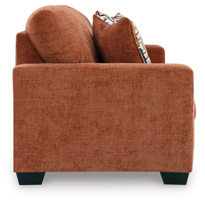 Ashley Furniture Aviemore Sofa with plush fabric and modern design, shown from a side angle in a living room setting.