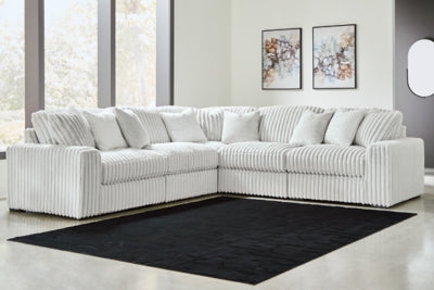 Ashley Furniture Stupendous sectional sofa with plush cushions and modern design, shown in a cozy living room setting.