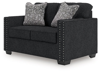 Ashley Furniture Jasmine Peaks loveseat featuring plush cushions and a stylish fabric upholstery in a cozy living room setting.