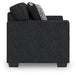 Ashley Furniture Jasmine Peaks loveseat with plush fabric and cushioned backrest, shown in a cozy living room setting.