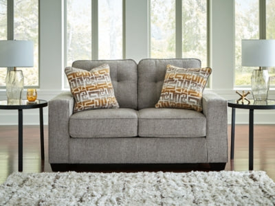 Ashley Furniture Larimer loveseat with plush fabric and cushioned armrests, shown in a cozy living room setting.