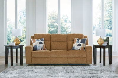 Ashley Furniture Kanlow reclining sofa with plush cushions and fabric upholstery, shown in a closed reclining position.