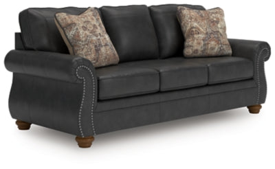 Ashley Furniture Chasemore sofa shown from an angled view, featuring plush cushions and a modern design in neutral upholstery.