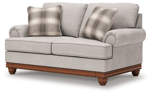Ashley Furniture Clearbrooke loveseat in a neutral fabric, shown from an angled view with plush cushions and tapered wooden legs.
