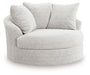 Ashley Furniture Cuddle Plush Oversized Swivel Accent Chair with soft fabric upholstery and plush cushioning, angled view.
