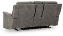 Ashley Furniture Next-Gen DuraPella power reclining loveseat with console, showing plush upholstery and built-in cup holders.