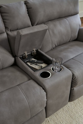 Close-up of Ashley Furniture Next-Gen DuraPella power reclining sectional showing textured fabric and reclining mechanism details.