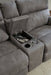 Close-up of Ashley Furniture Next-Gen DuraPella power reclining sectional showing textured fabric and reclining mechanism details.
