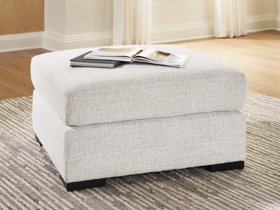 Misty-Lakes oversized accent ottoman by Ashley Furniture with plush fabric and a sturdy wooden base, shown in a modern living room setting.