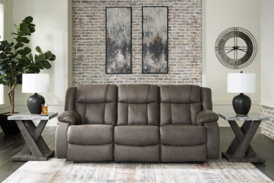 Ashley Furniture First Base reclining sofa with plush cushions and fabric upholstery, shown in a closed position.