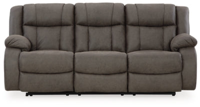 Ashley Furniture First Base reclining sofa with plush cushions and armrests, shown from a head-on view.