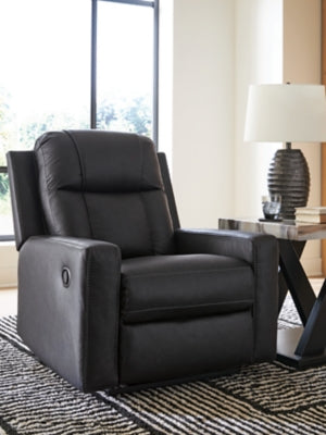 Ashley Furniture Mackmenville recliner in dark brown leather, showing a close-up of the cushioned armrest and plush backrest.