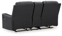 Ashley Furniture Mackmenville reclining loveseat with console, featuring plush fabric, padded armrests, and built-in cup holders.