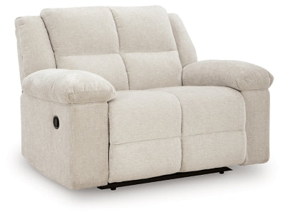 Ashley Furniture Orlen oversized recliner in brown leather, viewed from an angle showing the plush backrest and wide armrests.