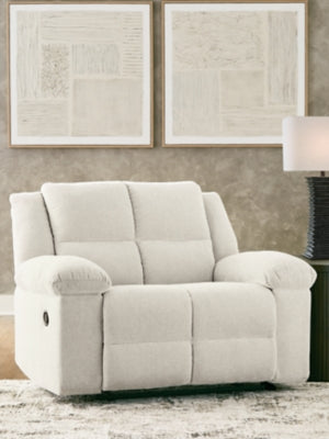Ashley Furniture Orlen oversized recliner in neutral fabric, showing its plush cushioned armrests and wide seating area.