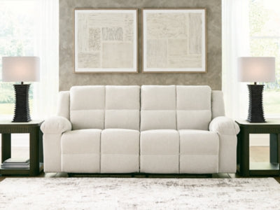 Ashley Furniture Orlen reclining sofa with plush cushions and neutral upholstery, shown in a close-up view.