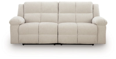 Ashley Furniture Orlen reclining sofa with plush cushions and a neutral fabric finish, shown from a head-on angle.