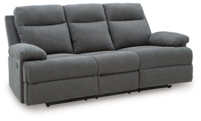 Ashley Furniture side-swipe reclining sofa with drop-down table, shown from an angled view with closed recliners and modern upholstery.