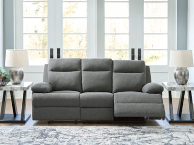 Ashley Furniture side-swipe reclining sofa with drop-down table, featuring plush cushions and built-in cup holders in a modern living room setting.