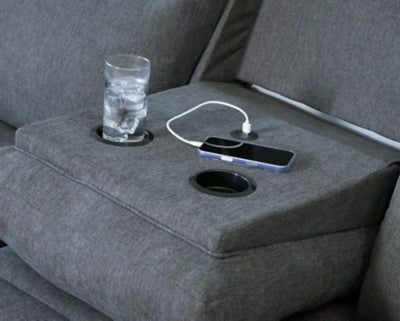Ashley Furniture side-swipe reclining sofa with built-in drop-down table and plush fabric, shown with extended footrest.