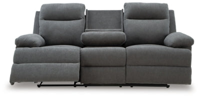 Ashley Furniture side-swipe reclining sofa with drop-down table, showing open reclining seats and built-in table in a living room scene.