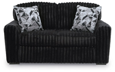 Ashley Furniture Midnight-Madness loveseat with plush fabric and cushioned armrests, shown from a front head-on angle.