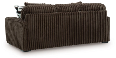 Ashley Furniture Midnight-Madness sofa with plush back cushions and sleek dark upholstery in a modern living room setting