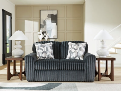 Ashley Furniture Midnight-Madness loveseat with plush dark upholstery and cushioned armrests, ideal for cozy living room seating.