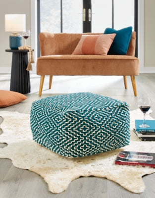Ashley Furniture Brynnsen pouf with soft fabric upholstery and round shape, suitable as a stylish accent piece in living rooms.
