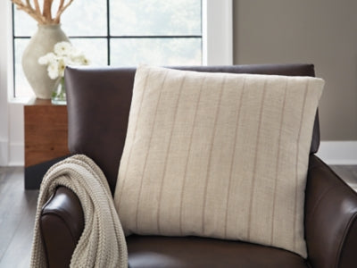 Set of four Ashley Furniture Valwick pillows with neutral fabric covers, arranged on a cozy sofa for stylish comfort.
