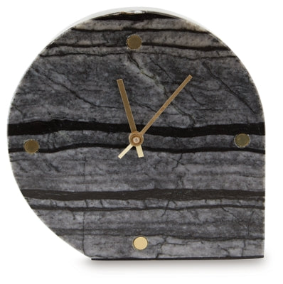 Two Ashley Furniture Janmour table clocks with sleek round designs, black faces, and silver-tone accents, set on a wooden surface.
