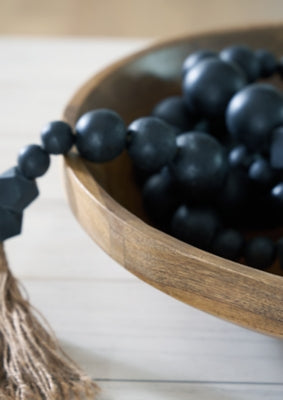 Ashley Furniture Clayburg Bowl showing a decorative ceramic bowl with intricate patterns and a glossy finish.