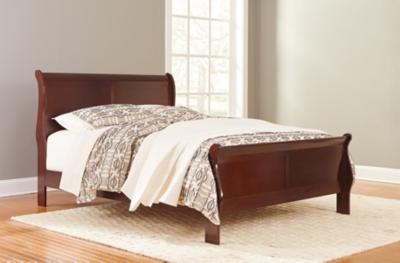 Ashley Furniture Alisdair Bed with a sturdy wooden frame and upholstered headboard, showcasing a modern bedroom design.