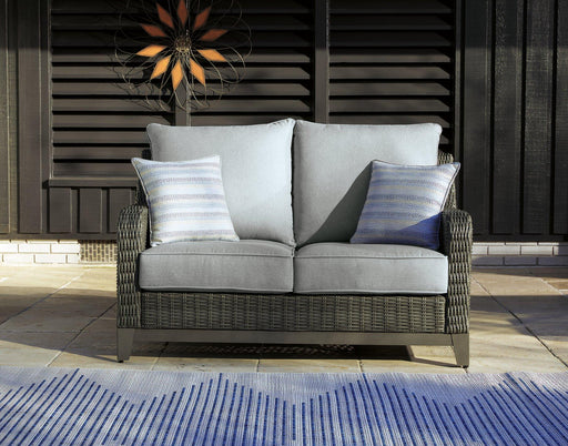 Outdoor loveseat by Ashley Furniture with cushioned seating, perfect for patio or garden relaxation.