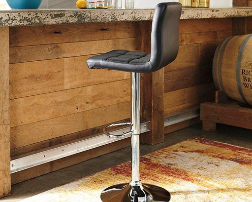 Adjustable height Ashley Furniture Bellatier barstool with wooden seat and metal frame, shown in a modern kitchen setting.