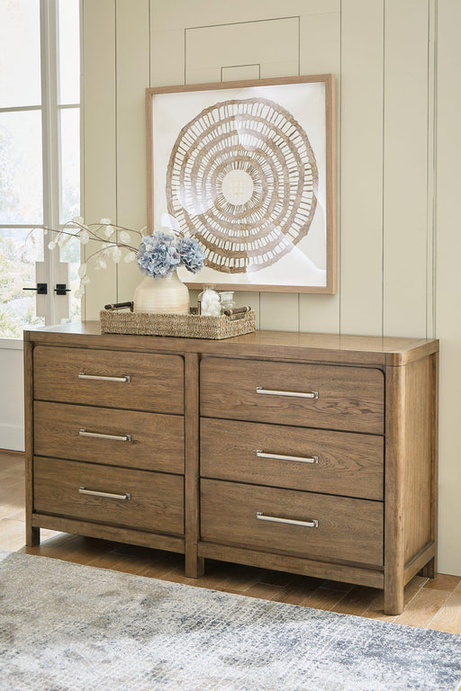 Ashley Furniture Cabalynn dresser with multiple drawers and a sleek wood finish, ideal for bedroom storage.