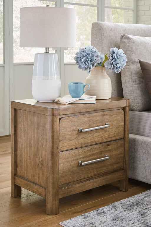 Cabalynn nightstand by Ashley Furniture featuring a modern design with a dark wood finish and sleek drawer handles.