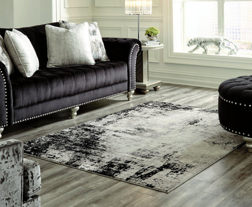 Ashley Furniture Zekeman 7'10" x 10' rug with intricate patterns and soft texture, perfect for adding style to any room.