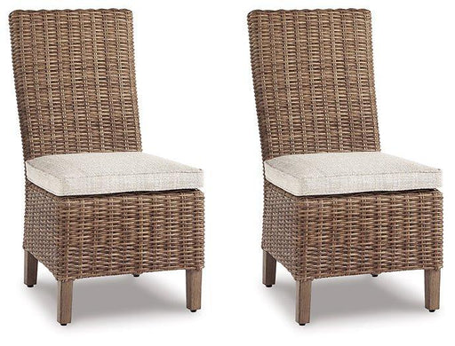 Set of two Ashley Furniture Beachcroft outdoor dining side chairs with cushions, ideal for patio or garden seating.