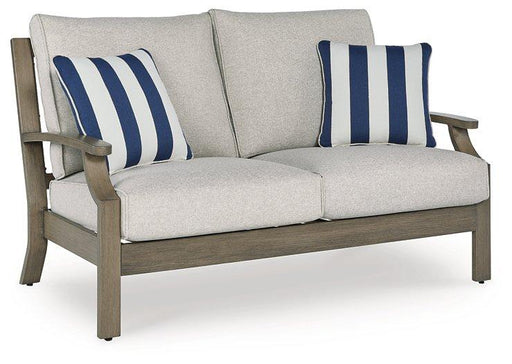 Outdoor loveseat with cushion from Ashley Furniture, Rainier Ranch style, featuring comfortable seating and stylish design.