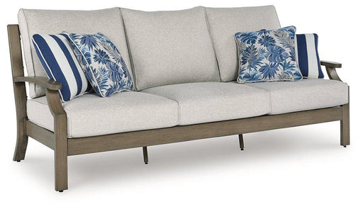 Outdoor sofa with cushions from Ashley Furniture, Rainier Ranch collection, featuring a stylish and comfortable design for outdoor living.