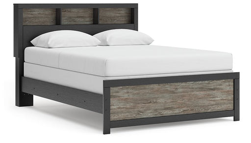 Ashley Furniture Broachmyn Bed with a dark wood finish, showing a stylish bed frame with a headboard and side panels in a bedroom setting.
