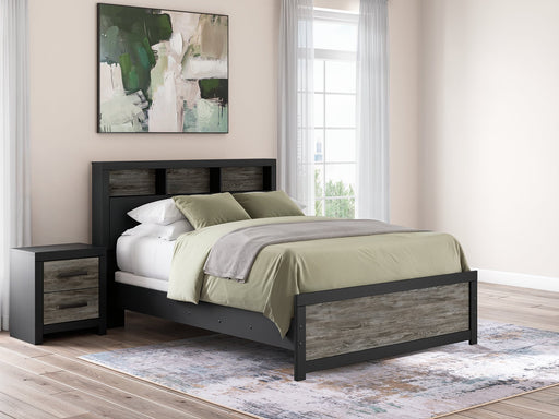 Ashley Furniture Broachmyn Bed with detailed wooden headboard and frame in a classic design, shown in a cozy bedroom setting.