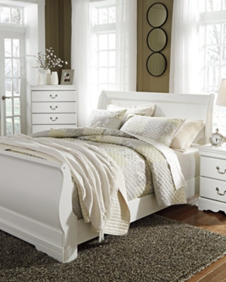 Ashley Furniture Anarasia bed with a contemporary wooden frame and upholstered headboard, shown in a modern bedroom setting.