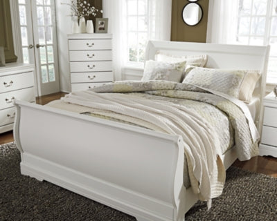 Ashley Furniture Anarasia Bed with elegant wooden frame and detailed headboard, showcased in a modern bedroom setting.