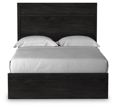 Ashley Furniture Belachime bed with a headboard featuring intricate wood design and a dark finish, shown from a front angle.