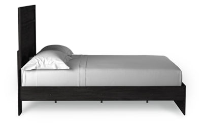 Ashley Furniture Belachime Bed with side view, showcasing the elegant wooden frame and detailed headboard design.